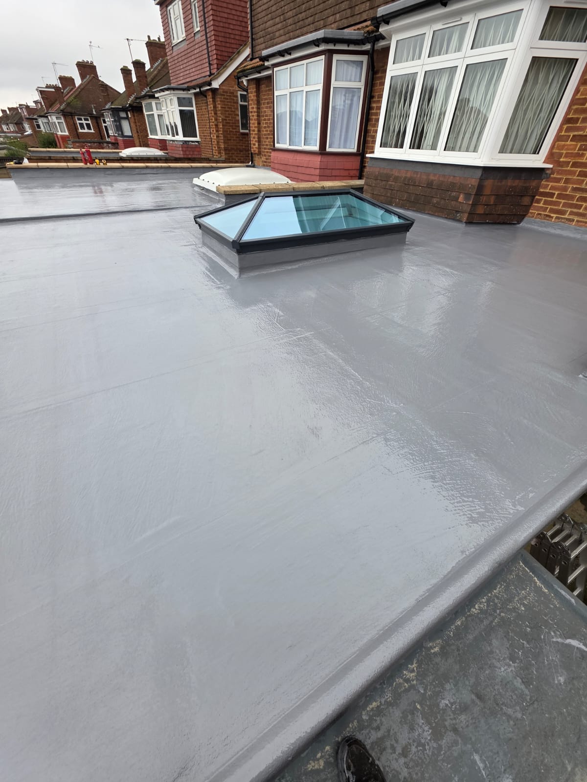 Liquid rubber coating application on roof